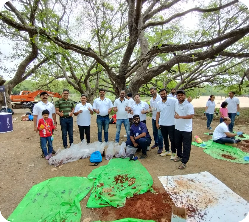 Hand placing seed balls on the ground after preparation